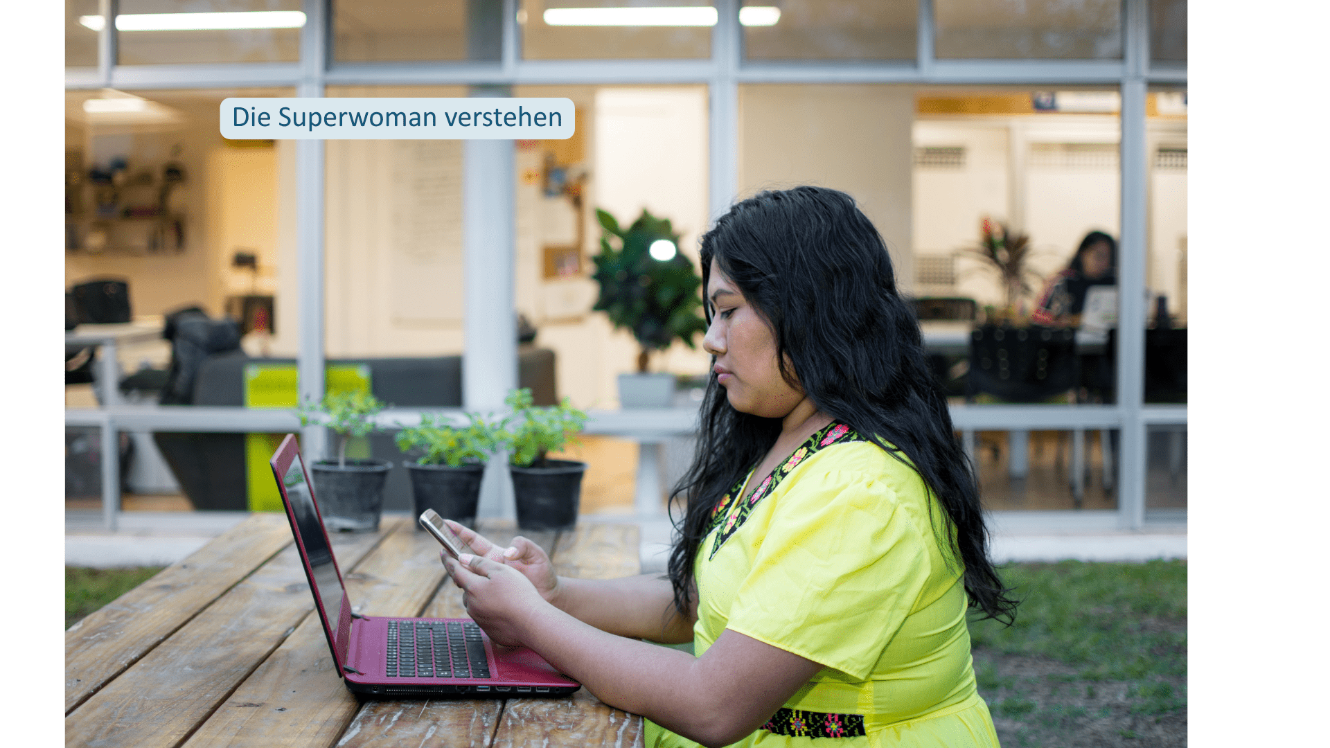 Frau arbeitet am Laptop und nutzt gleichzeitig ihr Smartphone – Superwoman-Muster beim Imposter-Syndrom